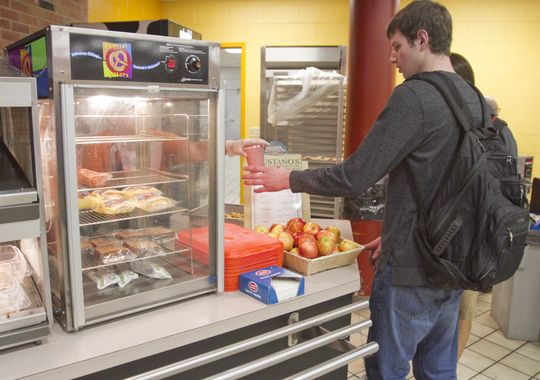 Brighton High School senior Seth Dorais and fellow students are served lunch at the school's cafeteria, which offers free or reduced-cost meals.(Photo: GILLIS BENEDICT/DAILY PRESS & ARGUS)