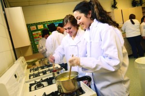 Paige Mulnix and Aubrey Denyes stir potatoes in boiling water in their ProStart class at North Branch High. Photo by Jon Tatting08