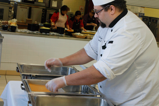 Leader Photo by Lee Pulaski Chef Josh Good sets up his station for the first lunch period Wednesday at Shawano Community Middle School. Good said preparing food helps him satisfy his urge to give to others.