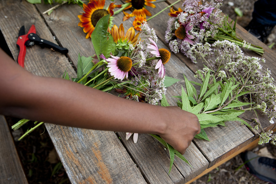 Students at Eastern Senior High School in Washington, D.C., trim bouquets to sell at the farmers market. Lydia Thompson/NPR